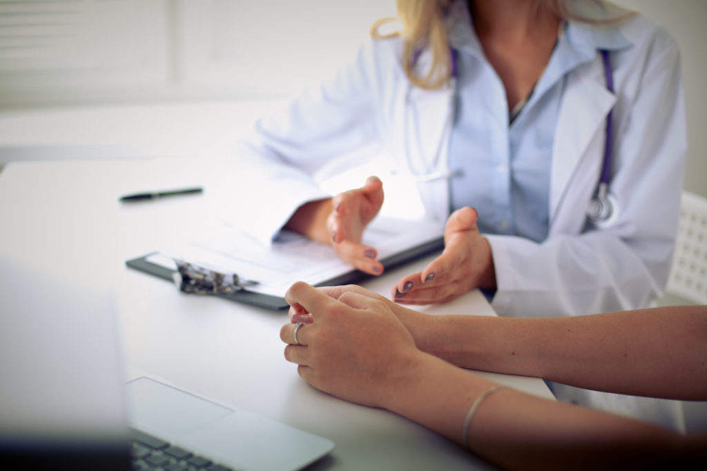 A conversation between a doctor and a patient in a doctor’s office.