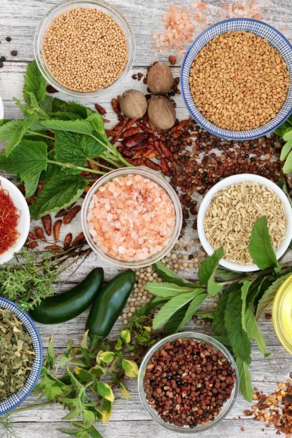 Herbs and spices on a wooden table.