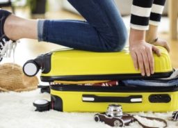 Packing a yellow suitcase.