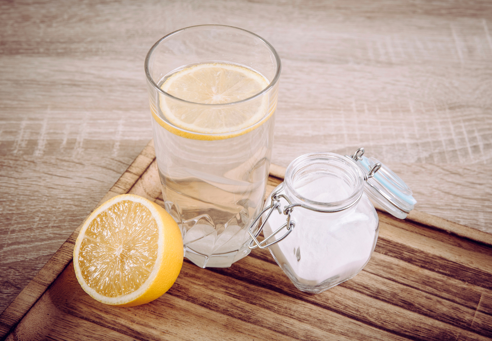 Baking soda in a glass jar for soaking and dissolved in a glass of Donat mineral water.