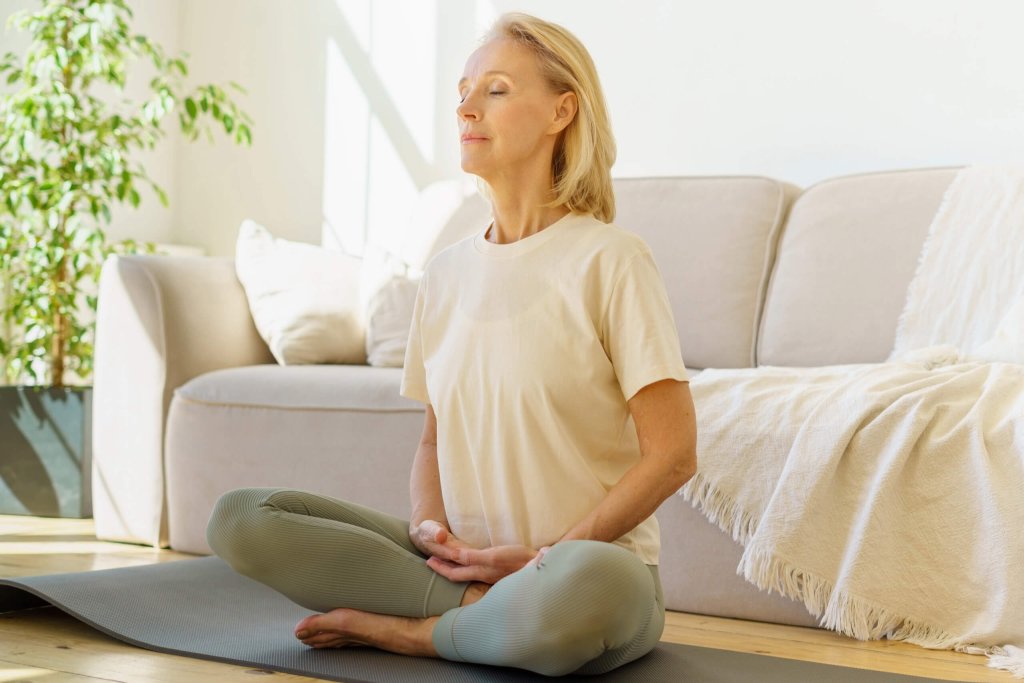 The woman is doing breathing exercises that can help alleviate heartburn.